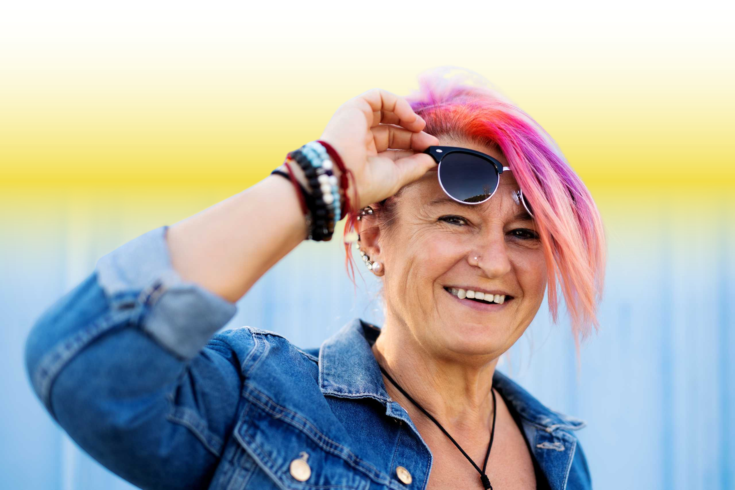 Senior woman with purple pink hair and sunglasses